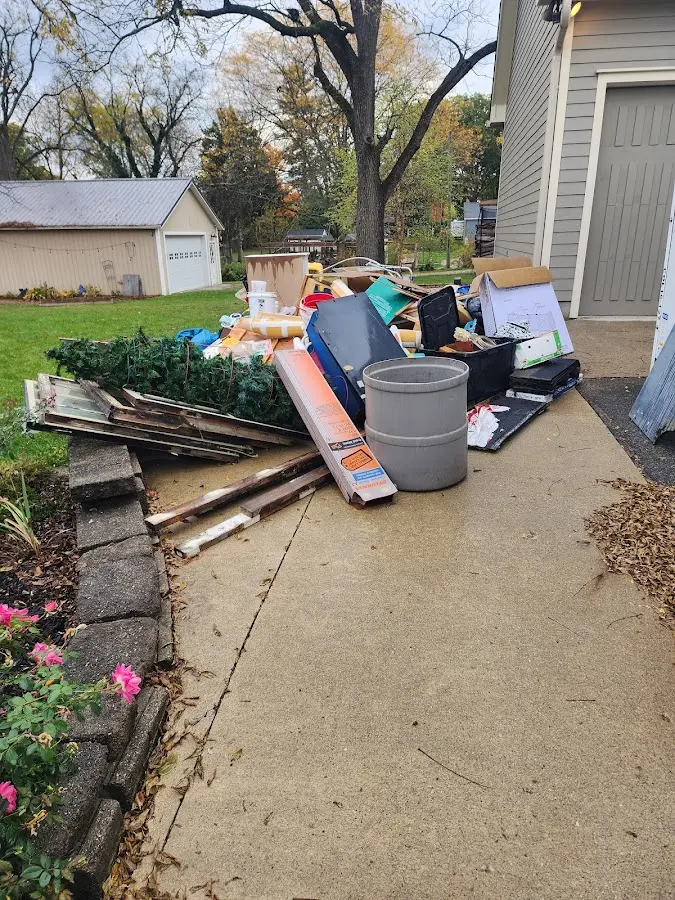 Dumpster being loaded with debris for Estate Cleanout Dumpster Rental in Rural Hall
